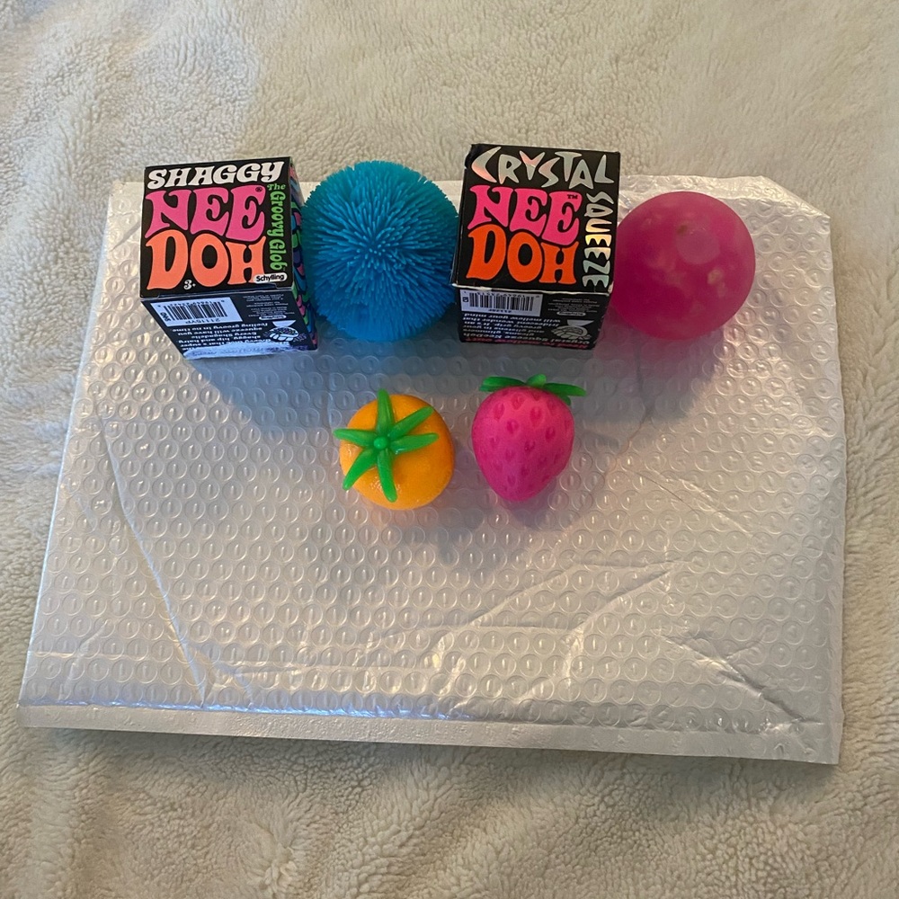 4 fidget toy Nee Doh! 2 fruit Nee Doh & 1 crystal Nee Doh & 1 shaggy Nee Doh!